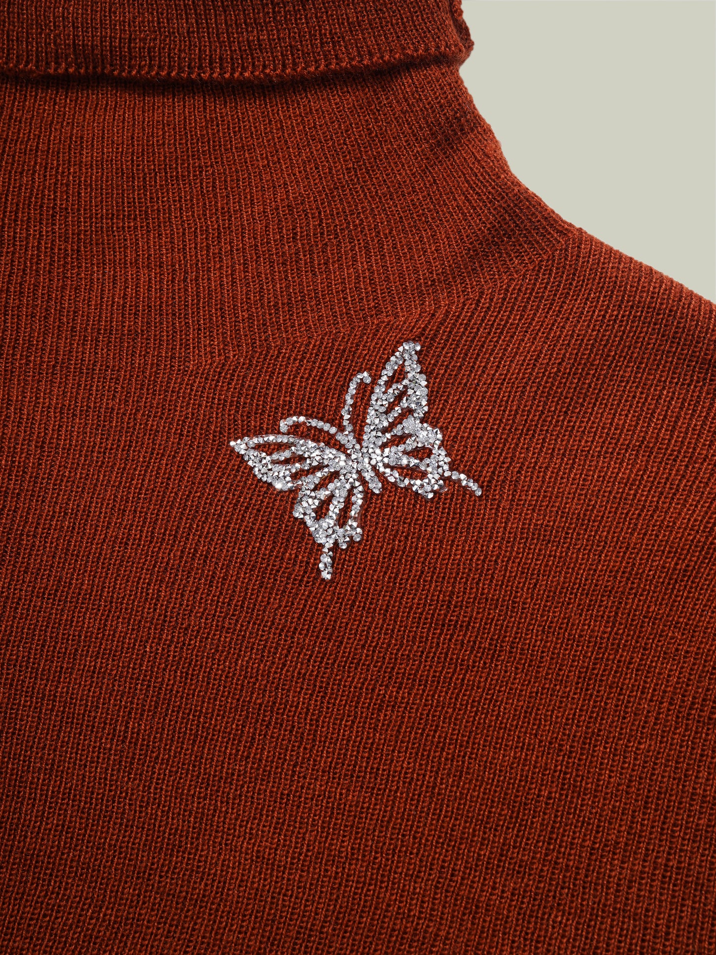 Butterfly embellished high-neck knit