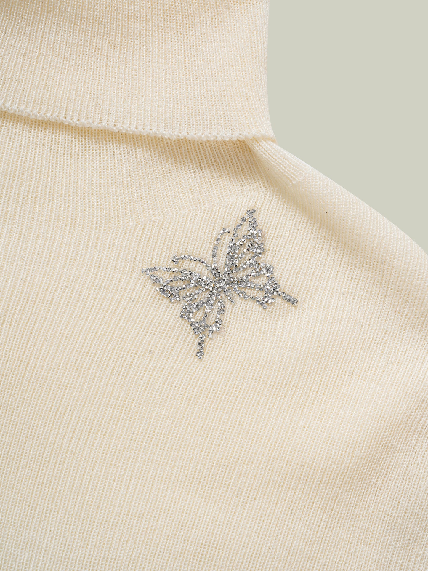 Butterfly embellished high-neck knit